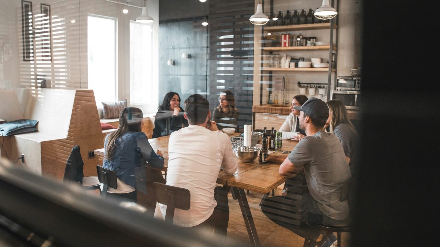 A small team talking around a kitchen table